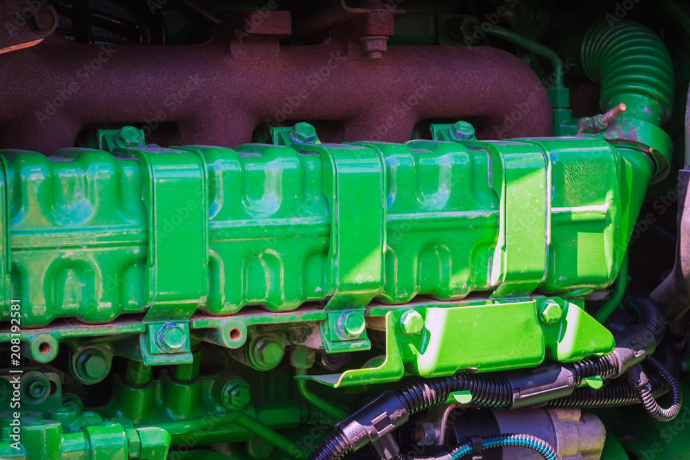 old tractor engine painted green with clamps and bolts old tractor engine painted green with clamps and bolts