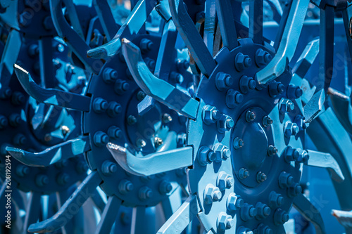 The blocks of the teeth of the rotary harrow are painted blue