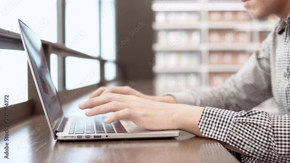 Asian university student man using laptop computer in college library. Young businessman typing on laptop keyboard in working space. freelance lifestyle or educational research concepts. 4K video Asian university student man using laptop computer in college library. Young businessman typing on laptop keyboard in working space. freelance lifestyle or educational research concepts. 4K video