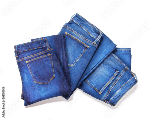 Jeans isolated on white background. Top view of folded blue jeans