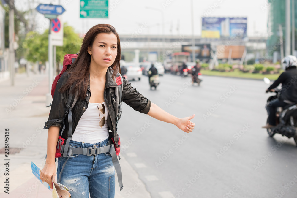 Young beautiful female traveler lost in the city