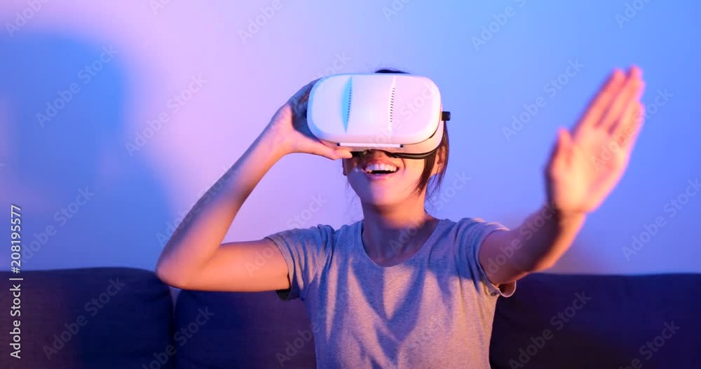 Woman watching with VR device at home Woman watching with VR device at home