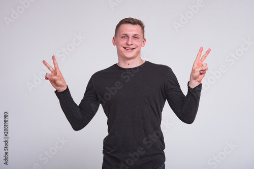 portrait of a cute young guy on a white background in different poses with different emotions. photo