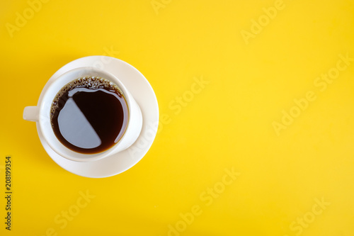 A cup of coffee on yellow background