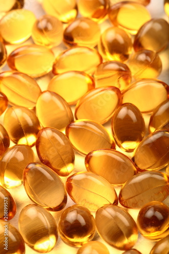 Many cod fish oil capsules background.