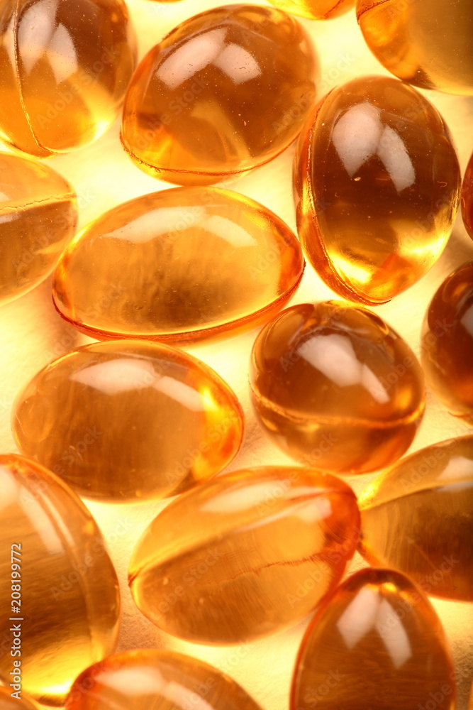 Macro photograph of cod fish oil capsules. Macro photograph of cod fish oil capsules.