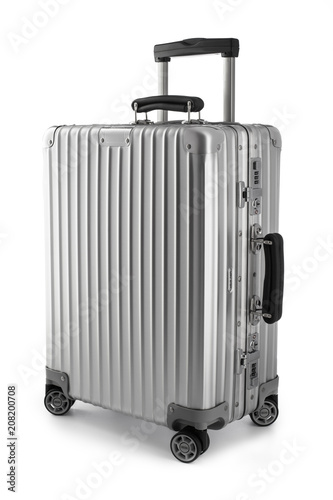 Suitcase or traveling luggage bag isolated on black background photo