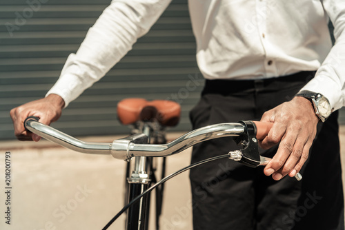 Cropped view of african american man holding his bicycle