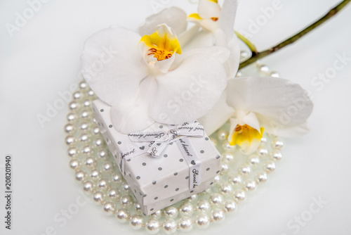 Gift box and white orchid on a white background 