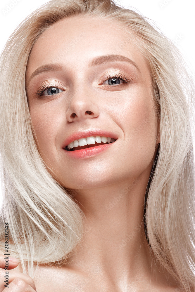 Beautiful young girl with a light natural make-up and perfect skin. Beauty face. Picture taken in the studio on a white background. Beautiful young girl with a light natural make-up and perfect skin. Beauty face. Picture taken in the studio on a white background.