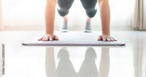 woman hand doing push ups exercise in a gym photo