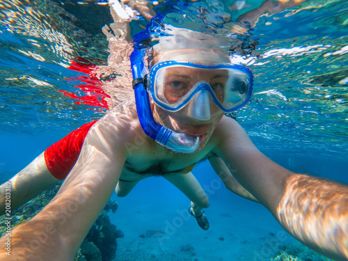 Couple snorkeling underwater in crystal clear water