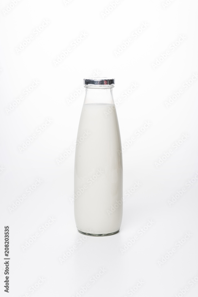 close-up shot of fresh milk in bottle on white surface close-up shot of fresh milk in bottle on white surface