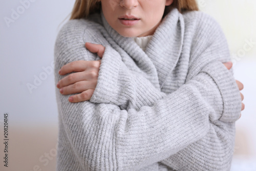 Woman suffering from cold on blurred background