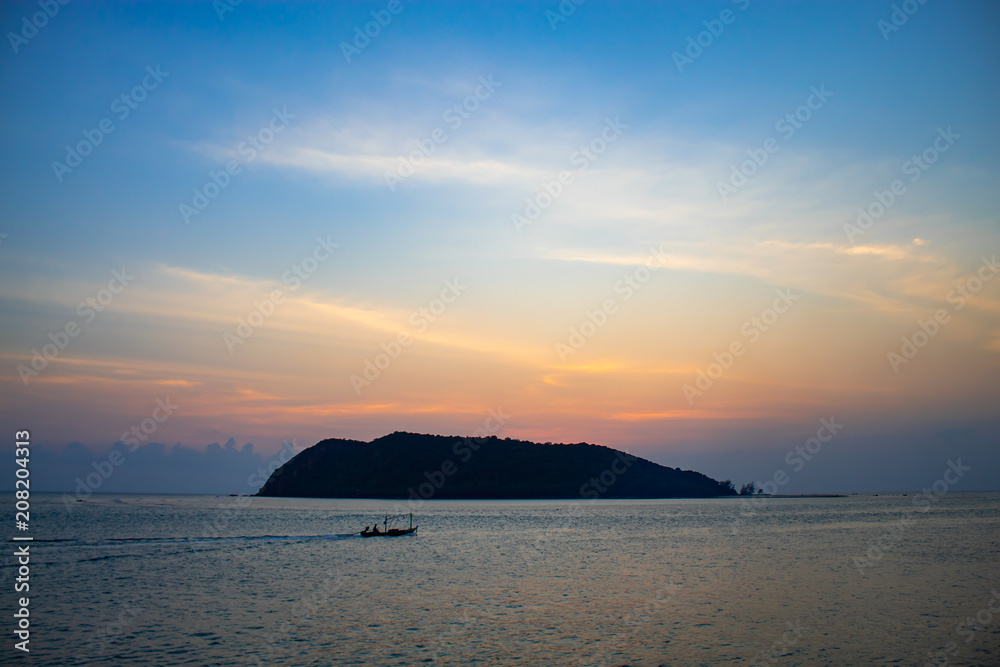 Sunset Behind an Island in the Sea at Koh Phaghan in Suratthani Thailand.