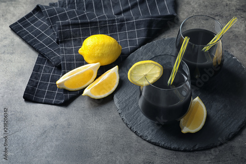 Glasses with natural black lemonade on table