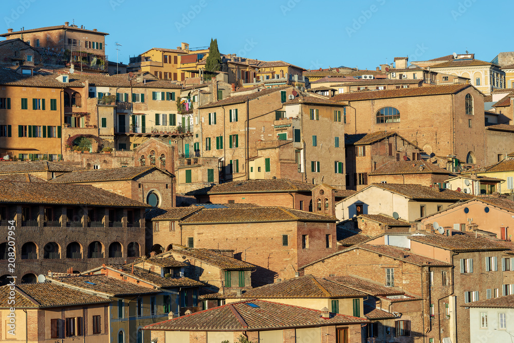 Siena with old houses in the evening. Tuscany, Italy, Europe