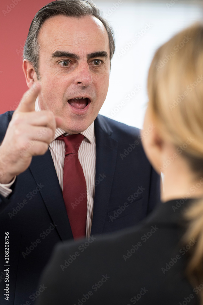 Aggressive Businessman Shouting At Female Colleague