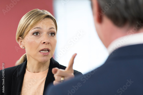 Aggressive Businesswoman Shouting At Male Colleague
