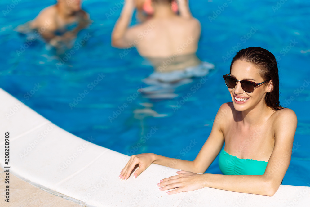 Sexy woman enjoying summer in pool