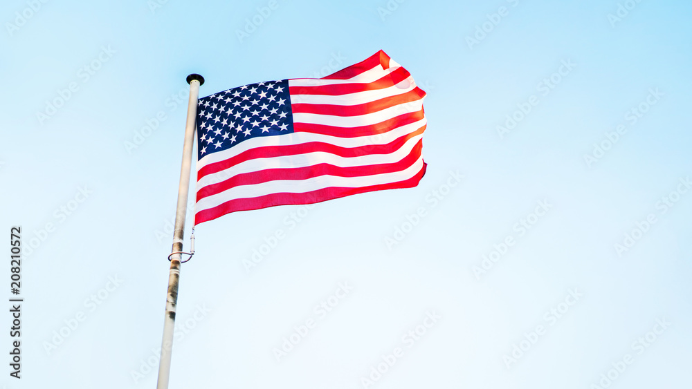 Fototapeta premium American flag fluttering on the wind. USA holidays banner.