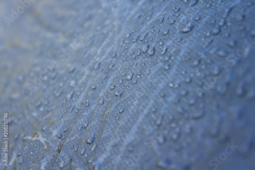 Rain drops on the surface of a tourist tent taken close-up