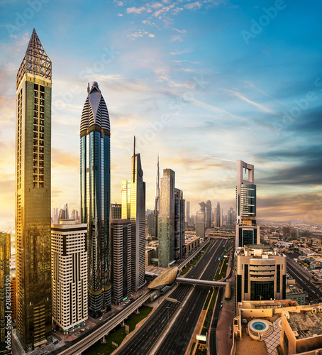 Dubai downtown sunset panoramic view with modern skyscrapers.