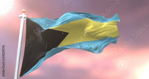 Bahamas flag waving at wind in slow at sunset, loop photo