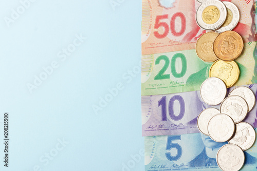 Canadian banknotes on blue background