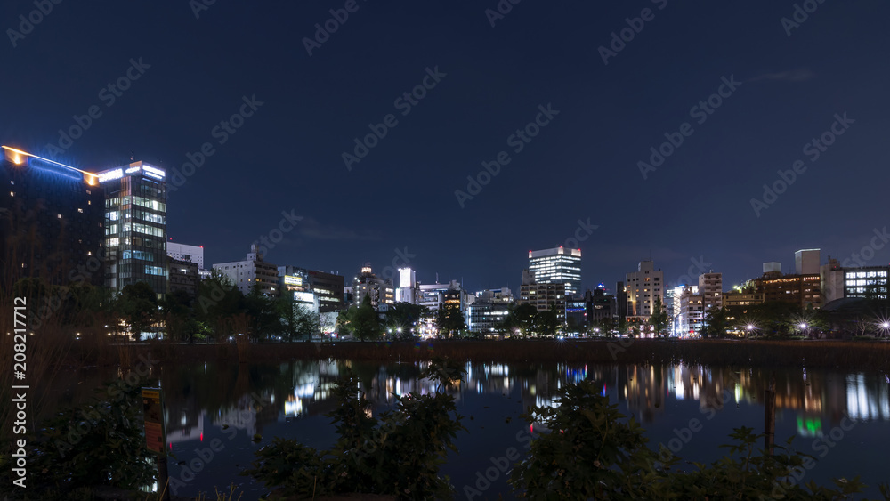 Beautiful night view of the Ueno district of Tokyo, Japan, with reflection in the Shinobazuno pond