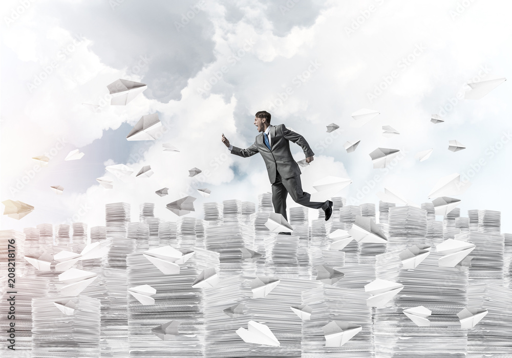 Precise businessman in suit running with phone. Precise businessman in suit running with phone.