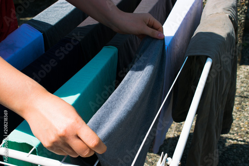 Young woman hanging laundry outdoor