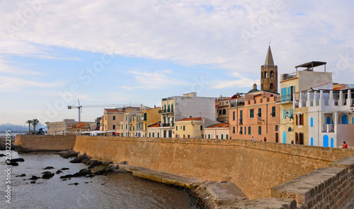cloudly sky, sea, colorful old buildings and architecture in coastal city Alghero in Sardinia, Italy 