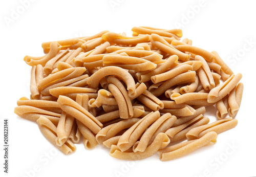 Heap of raw pasta on white background