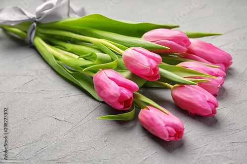 Fototapeta Naklejka Na Ścianę i Meble -  Bouquet of beautiful tulips on grey textured background