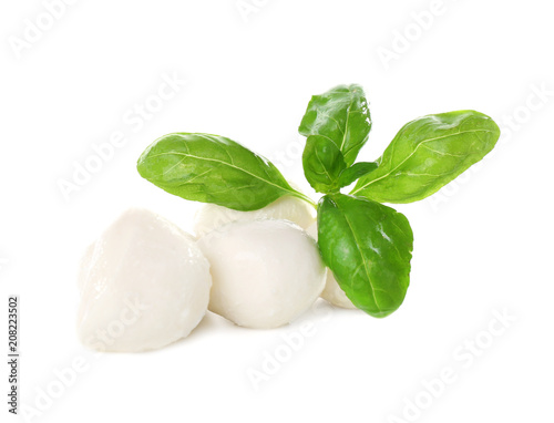 Mozzarella cheese balls and basil on white background