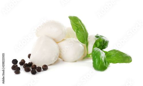 Mozzarella cheese balls and basil on white background