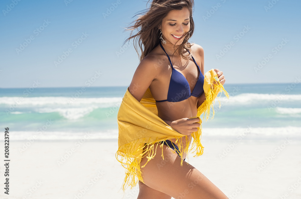 Happy woman with scarf at beach - obrazy, fototapety, plakaty 