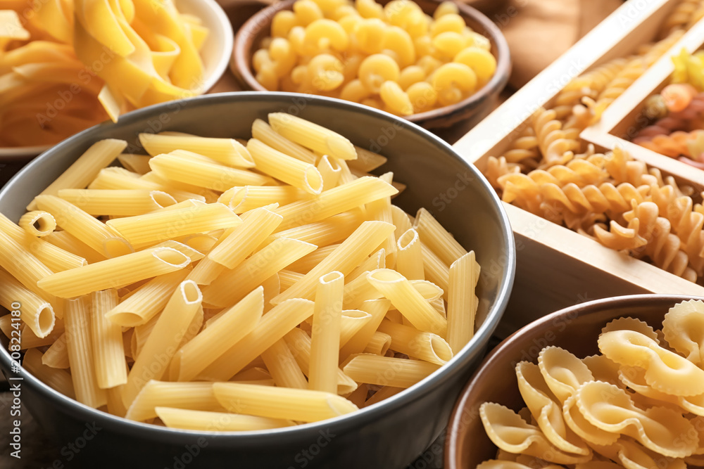 Different uncooked pasta on table, closeup Different uncooked pasta on table, closeup