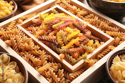 Different uncooked pasta on table, closeup