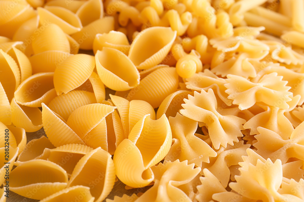 Different uncooked pasta as background, closeup Different uncooked pasta as background, closeup