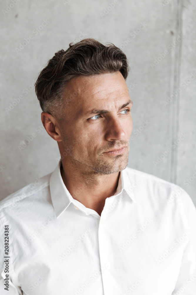Fototapeta premium Close up portrait of a handsome man in white shirt