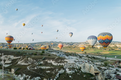 front view of hot air balloons flying over cityscape, Cappadocia, Turkey