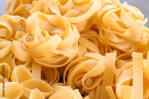 Uncooked pasta as background, closeup