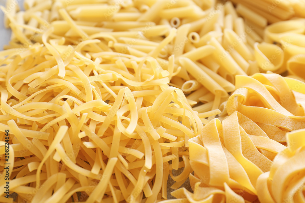 Different uncooked pasta as background, closeup Different uncooked pasta as background, closeup