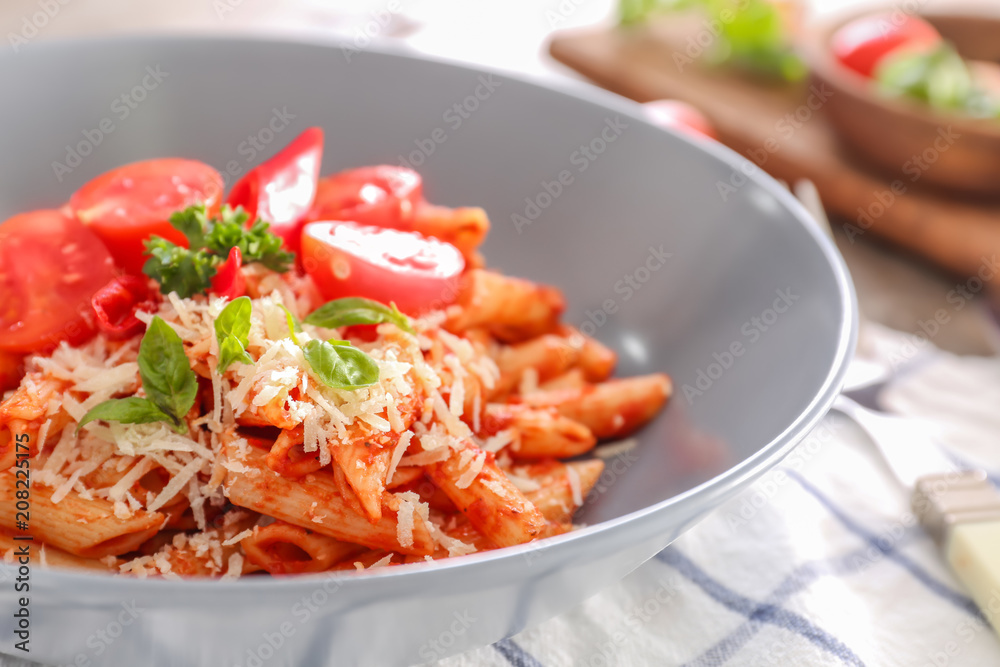 Tasty pasta with tomato sauce and cheese on plate, closeup