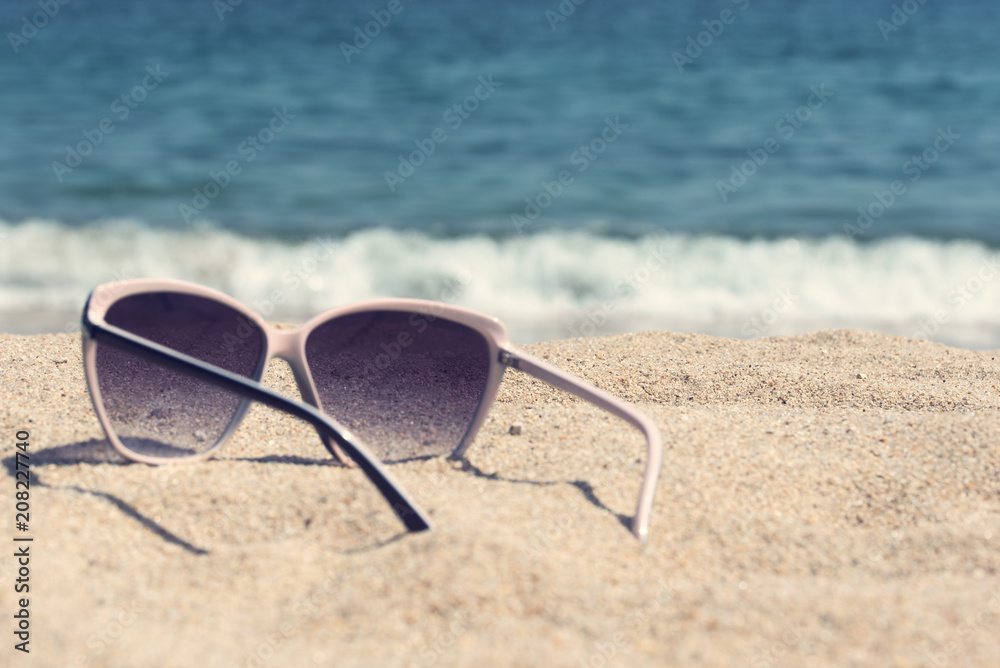 glasses on the beach sand
