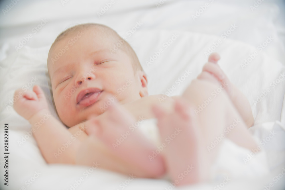 close-up baby newborn infant lying in bed close-up baby newborn infant lying in bed