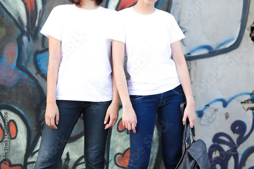 Two Girlfriends Wearing Plain White T-Shirt, Boyfriend Jeans, Teen Urban Clothing Style.