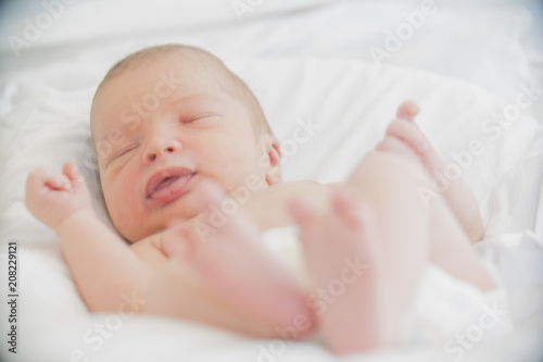 close-up baby newborn infant lying in bed